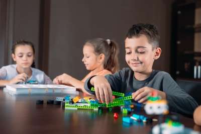 three children playing at the desk children playing