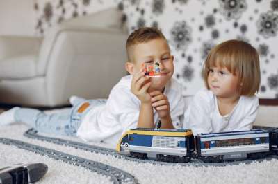 brother and sister playing with toys boy and girl playing on the floor