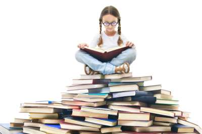 girl on top of the bunch of books reading