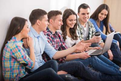 adults students sitting on the floor talking a group of adult students