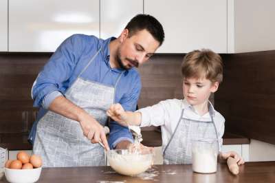 male teacher and child having a cooking class