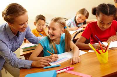 teacher helping a girl