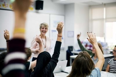 students raising hands