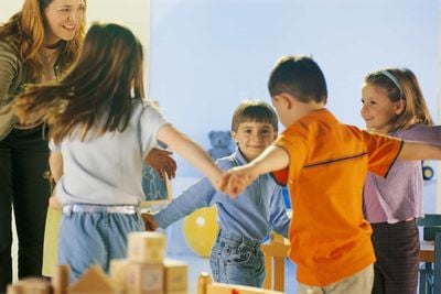 children and teacher playing