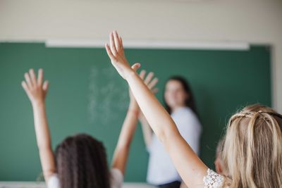 children raising hands