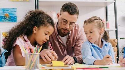 teacher helping students