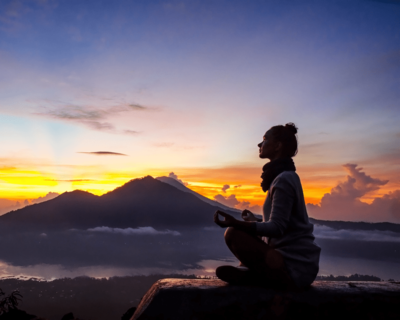 girl meditating mountain view