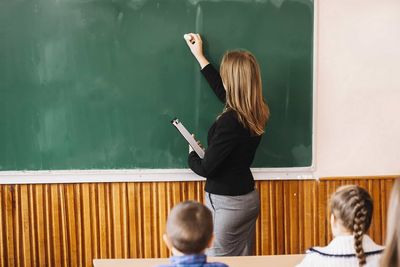 teacher writing on the blackboard