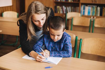 teacher helping a student