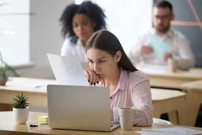 pretty lady sitting in front of the laptop