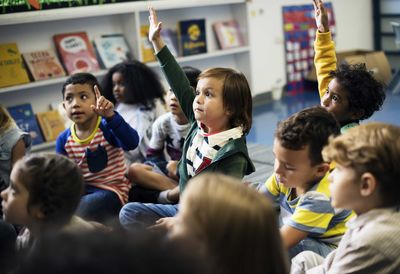 children raising hands