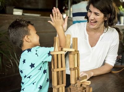 teacher and student giving high five to each other