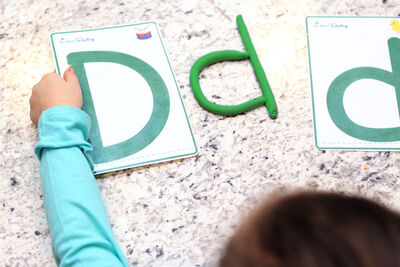 child spelling with playdough