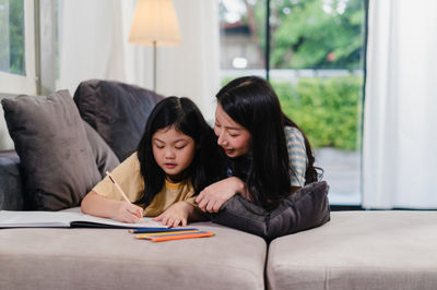 woman and girl doing homework