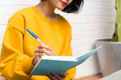 teacher writing in the notebook