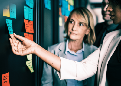 women in front of board