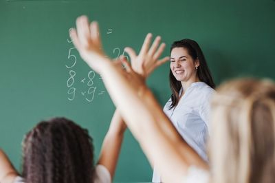 students raising hands