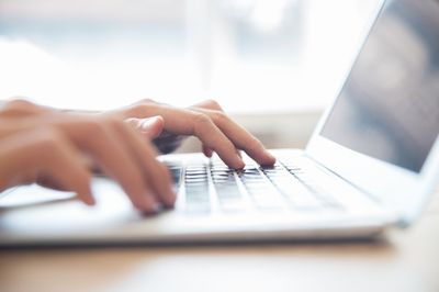 hands on the laptop keyboard