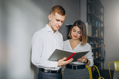 two young TEFL teachers looking at the paper plan