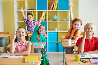 children raising hands