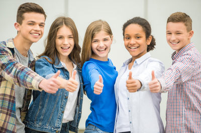 group of happy teenage students