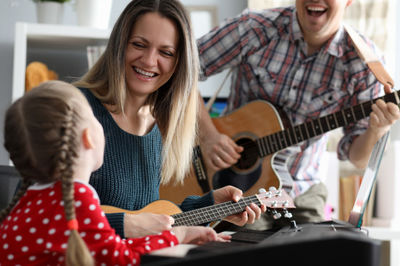 two adults and a girl