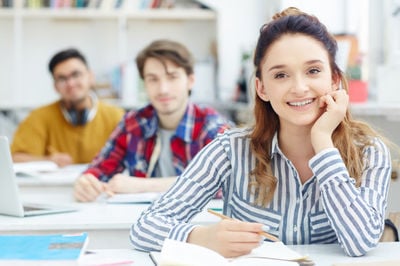 female student and two male students on the background