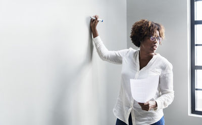 african lecturer writing on the whiteboard