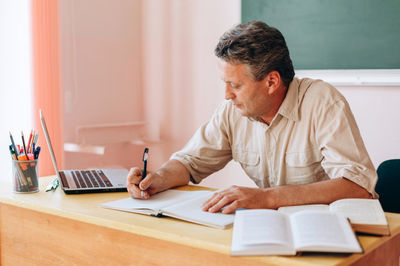 teacher sitting at desk working