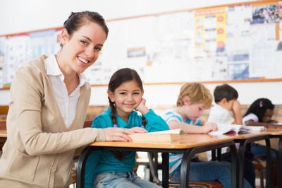 teacher and a student smiling