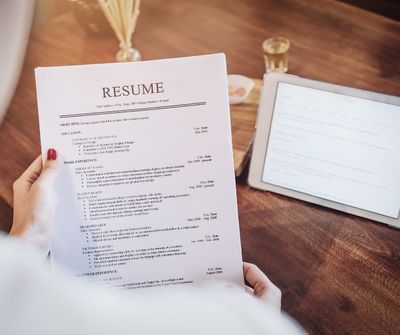 woman holding resume at desk