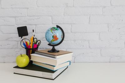 books and a globe on top of them