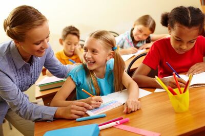 teacher helping a girl