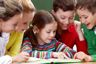 children looking in the book