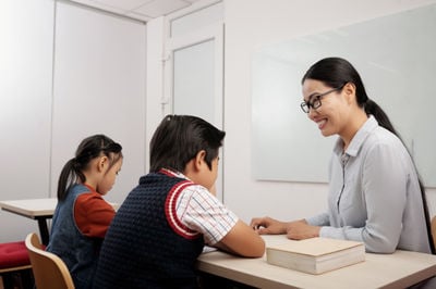 asian students and teacher in class