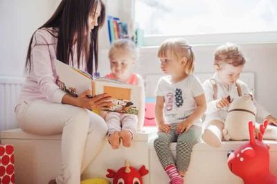 kindergarten teacher and children