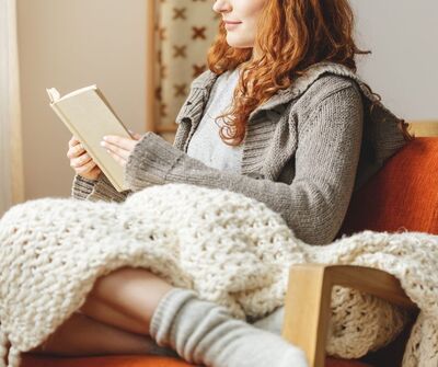 woman reading on couch