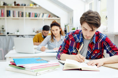 students sitting at their desks and writing