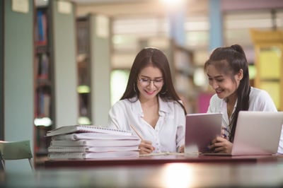 two young ladies in the library